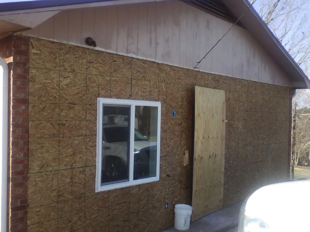 OSB sheathing on a garage addition wall before siding in Noxen