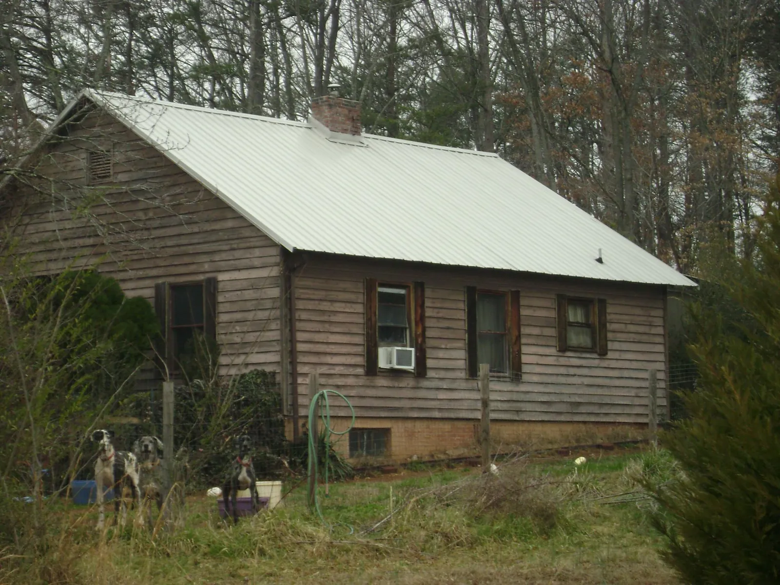 White metal roof on an old wood sided farmhouse, from a Metal Roof Installation job in Noxen